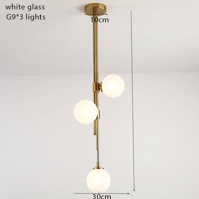 Suspension tube doré et boules en verre moderne
