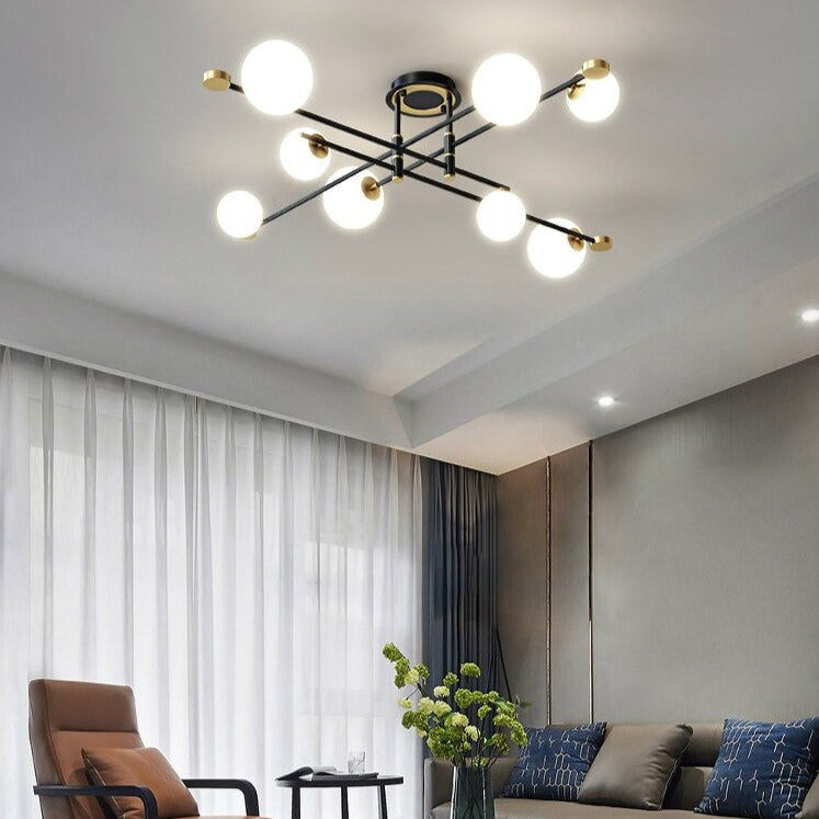 Lustre moderne LED bras croisés noirs et détails dorés Poline