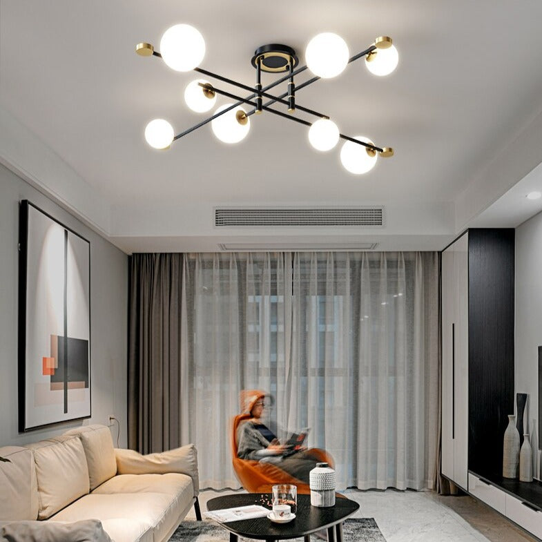 Lustre moderne LED bras croisés noirs et détails dorés Poline