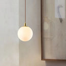 Modern minimalist brass pendant light with luminous orb