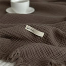 Plaid coton doux a carreaux avec pompons salon