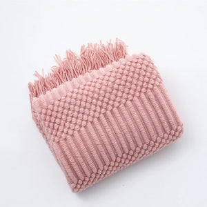 Lightweight knitted throw with pom-poms for sofa or bed