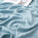 plaid tricoté à pompons motif jacquard nordique
