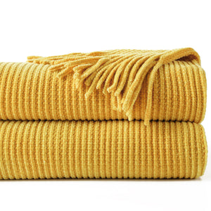 Chenille knit throw with pom-poms and decorative check pattern