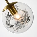 Applique design boule en verre remplie de feuilles dorées suspendue