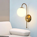 Simple gold wall light with globe