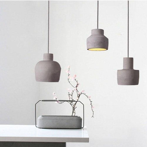 Suspension design à LED avec abat-jour arrondie en ciment