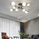 Lustre moderne LED bras croisés noirs et détails dorés Poline